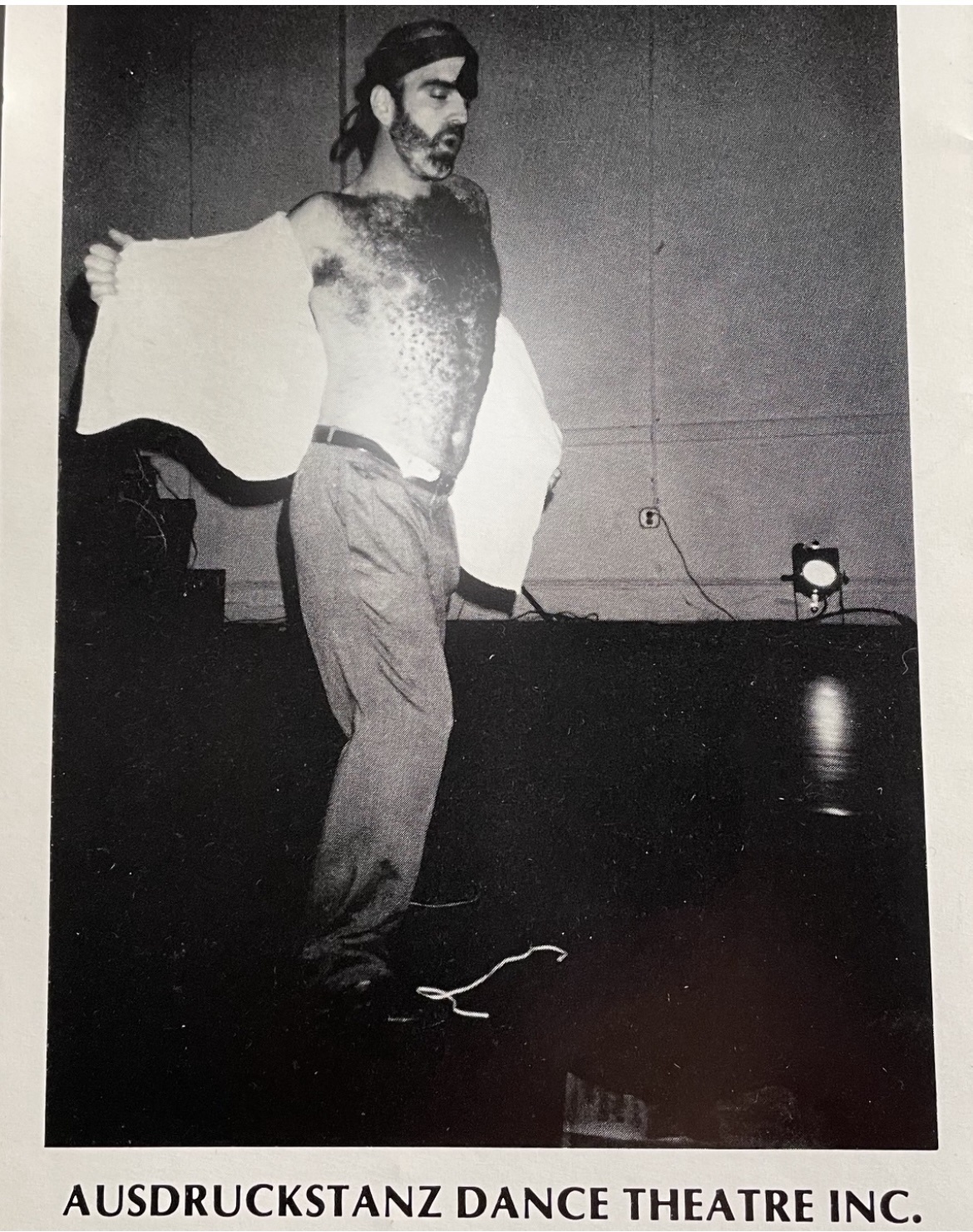 Michael A. Carson performing his solo from Privatleben on stage with his shirt open